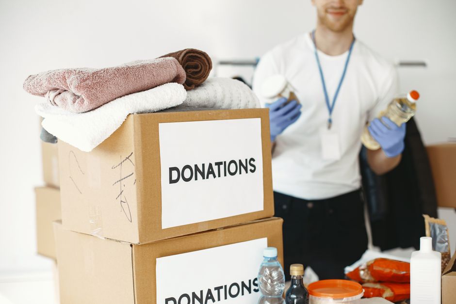 Volunteers sorting donated clothing and essentials into boxes